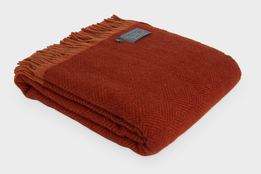 Folded red wildweave wool throw by The British Blanket Company