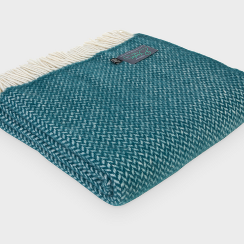 A folded green herringbone wool blanket by The British Blanket Company. 