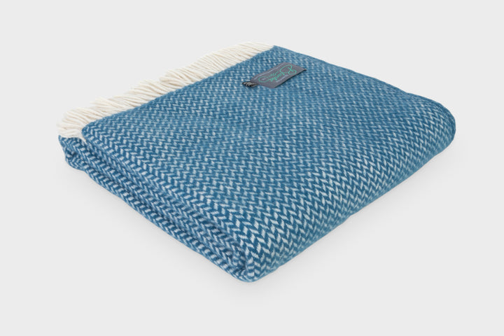 Folded blue herringbone wool throw by The British Blanket Company