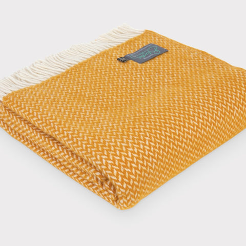 Folded large yellow herringbone wool throw by The British Blanket Company