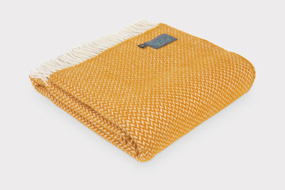 Folded XL yellow herringbone wool throw by The British Blanket Company