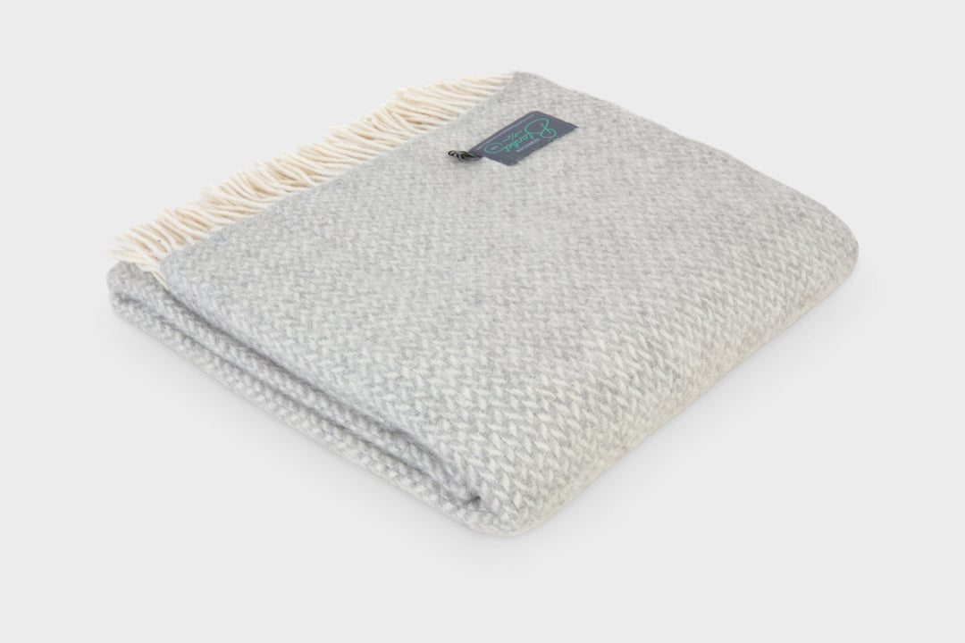 Folded XL silver grey herringbone wool throw by The British Blanket Company