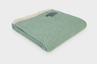 Folded XL green herringbone wool throw by The British Blanket Company