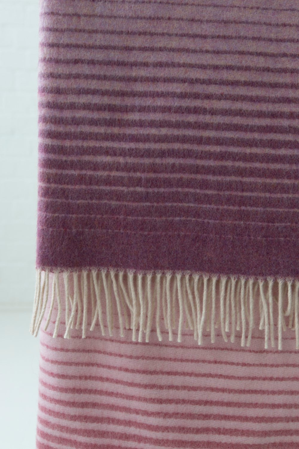 Closeup of a pink ombre merino wool throw