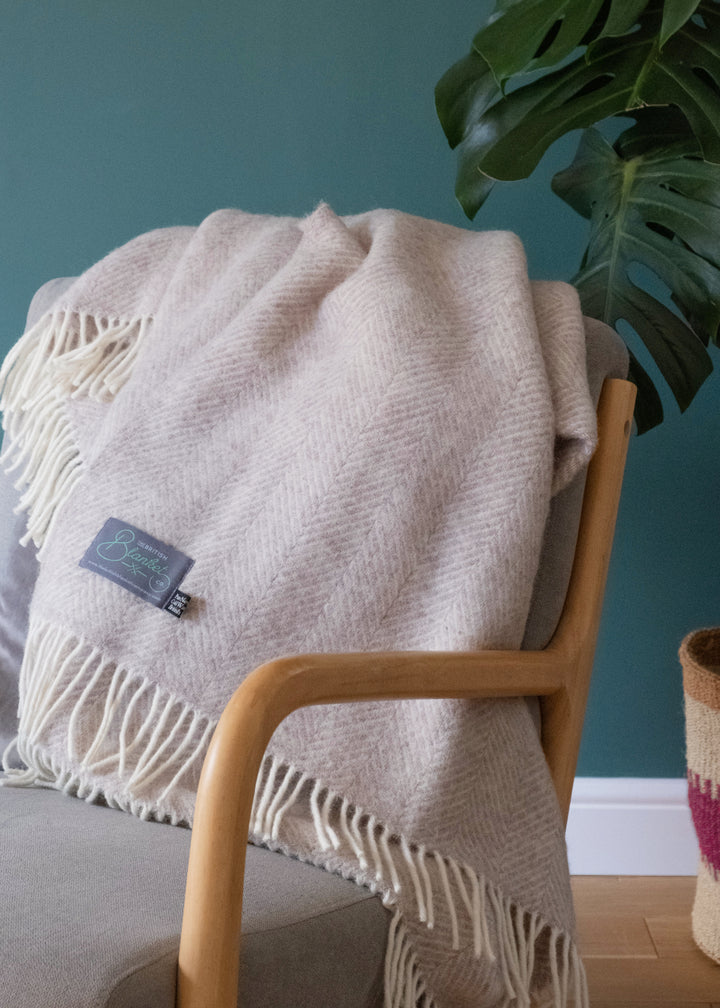 beige wool herringbone throw blanket by The British Blanket Company draped over a chair