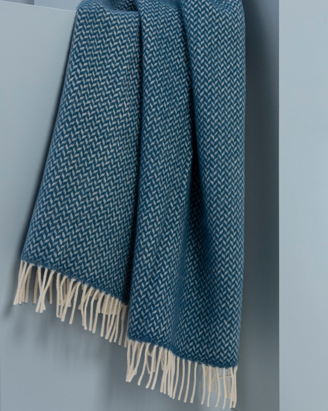 A large blue herringbone wool blanket