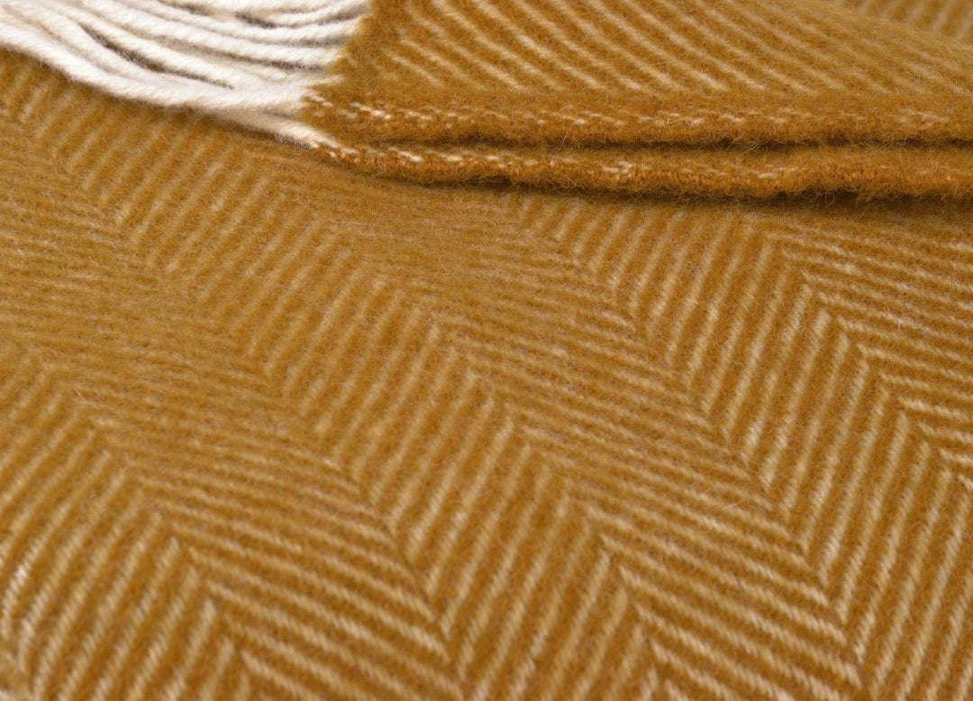 Closeup of large yellow herringbone wool throw