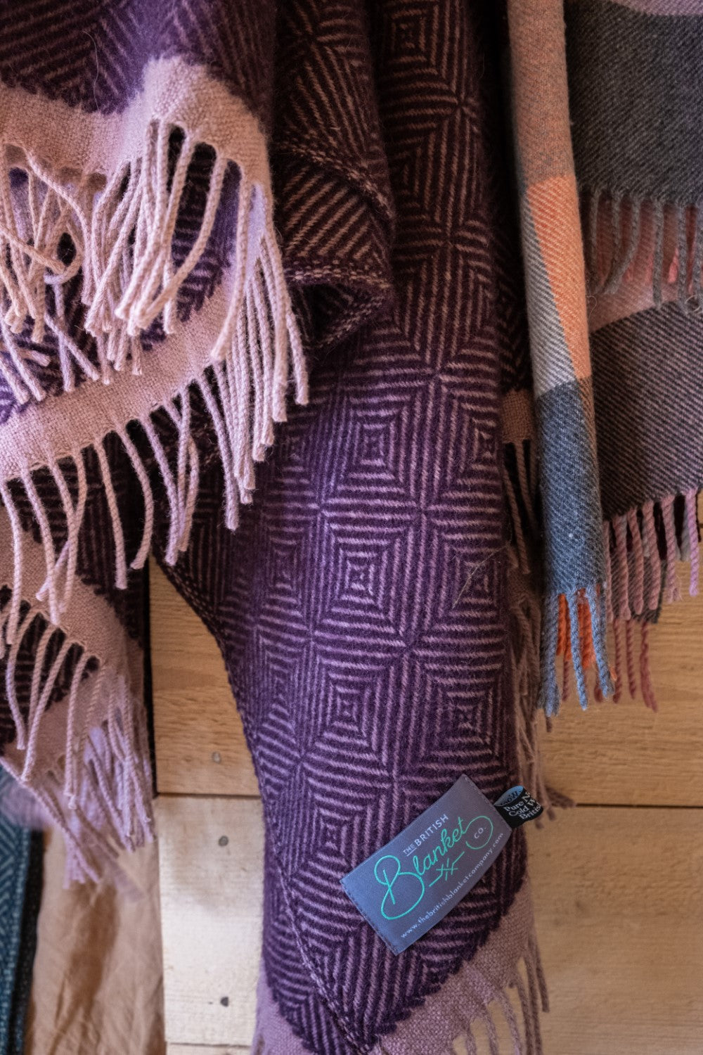 Closeup of a hanging purple wildweave wool throw by The British Blanket Company