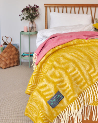 light and bright bedroom decor styled with yellow and pink wool throw blankets by The British Blanket Company online shop