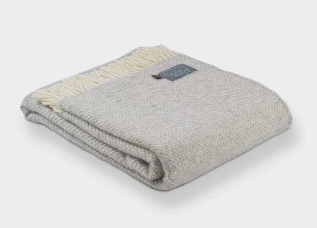 Folded silver grey herringbone wool throw by The British Blanket Company