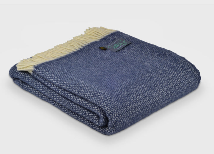 Folded blue windmill wool throw by The British Blanket Company