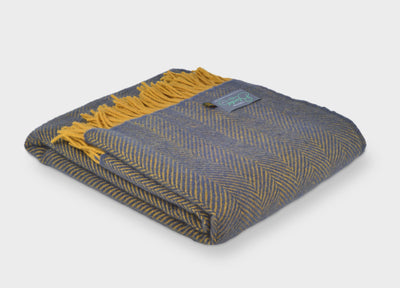 Folded large blue and yellow herringbone wool throw by The British Blanket Company