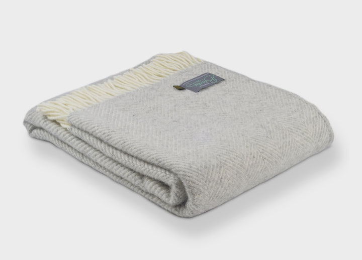 Folded XL silver grey herringbone wool throw by The British Blanket Company