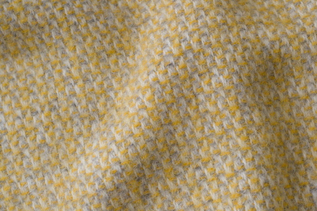 Closeup of yellow and grey windmill wool blanket