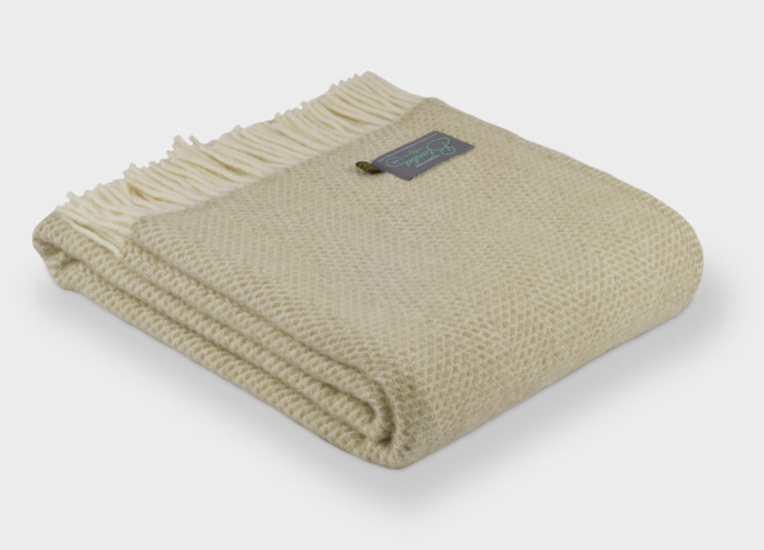 Large folded beige beehive wool throw by The British Blanket Company