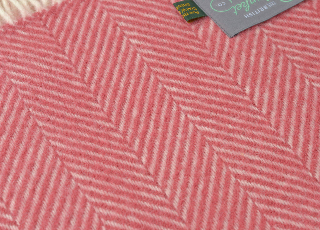 Closeup of a large red herringbone wool throw by The British Blanket Company
