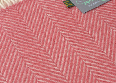 Closeup of a large red herringbone wool throw by The British Blanket Company