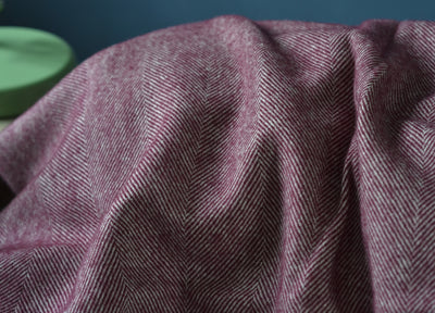 Closeup of large purple merino herringbone wool blanket.