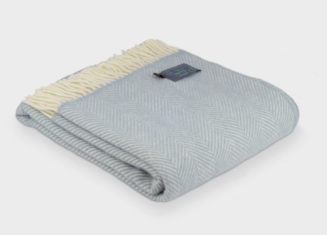 Folded blue herringbone wool blanket by The British Blanket Company.