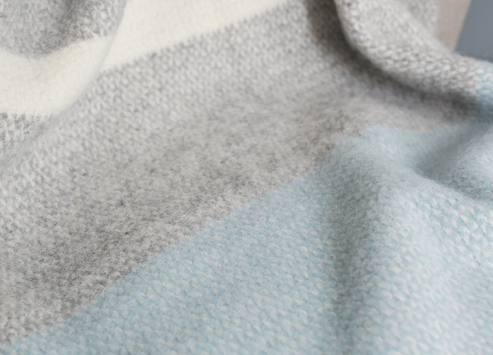 Closeup of grey and blue wool throw by The British Blanket Company.