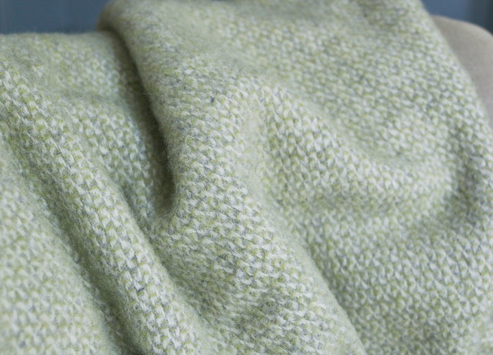 Closeup of a green and grey windmill wool blanket