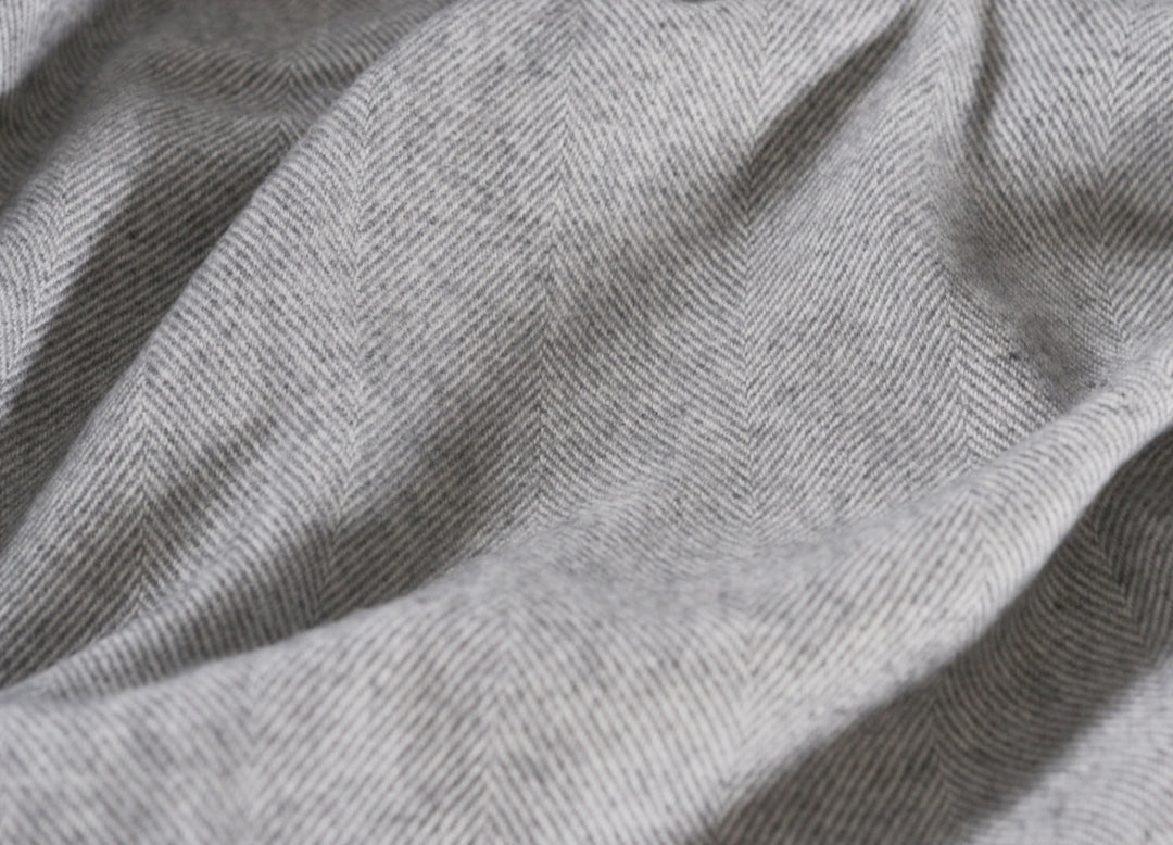 Closeup of a large grey merino herringbone wool blanket