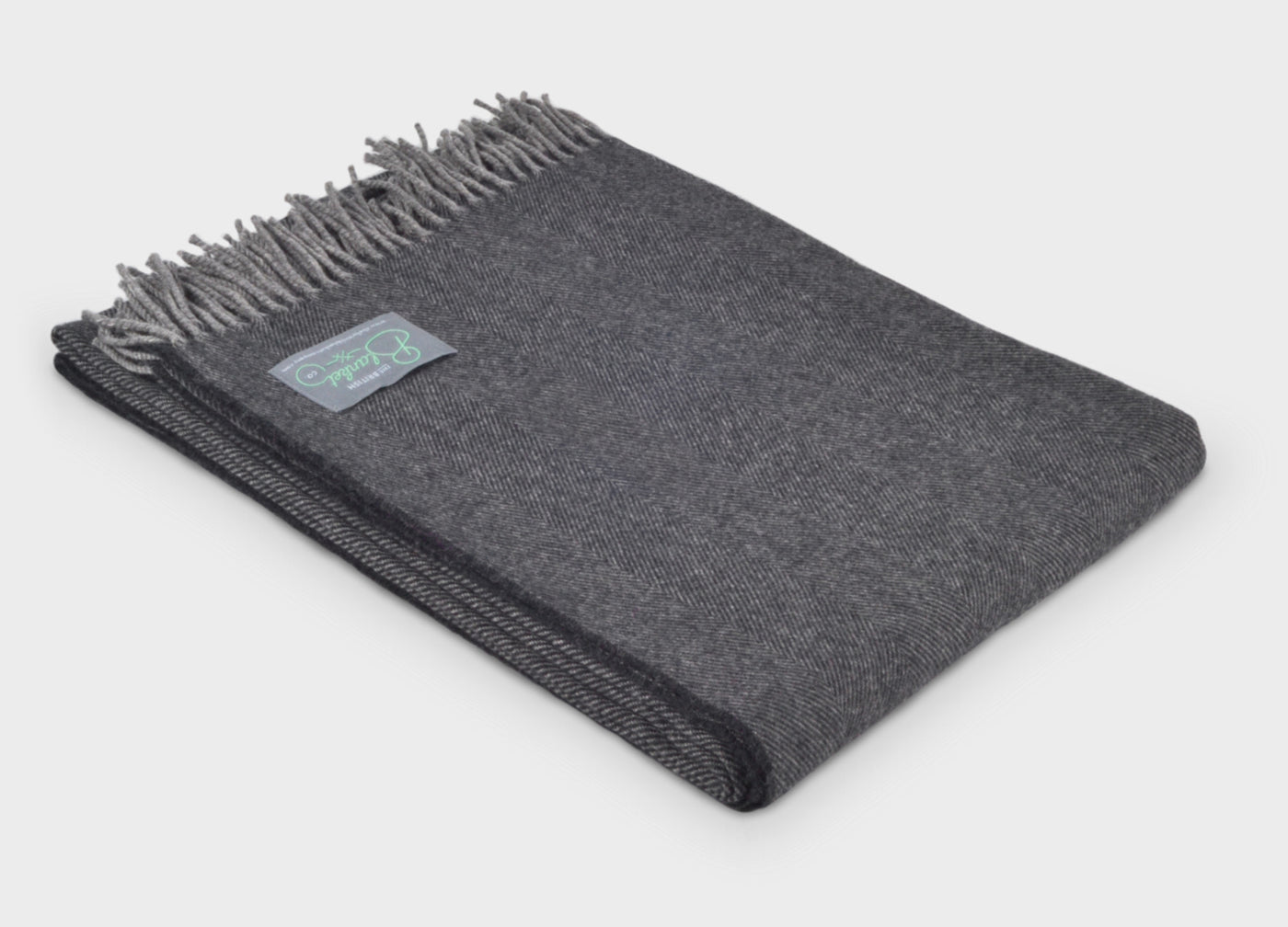 Folded grey merino herringbone wool throw by The British Blanket Company.