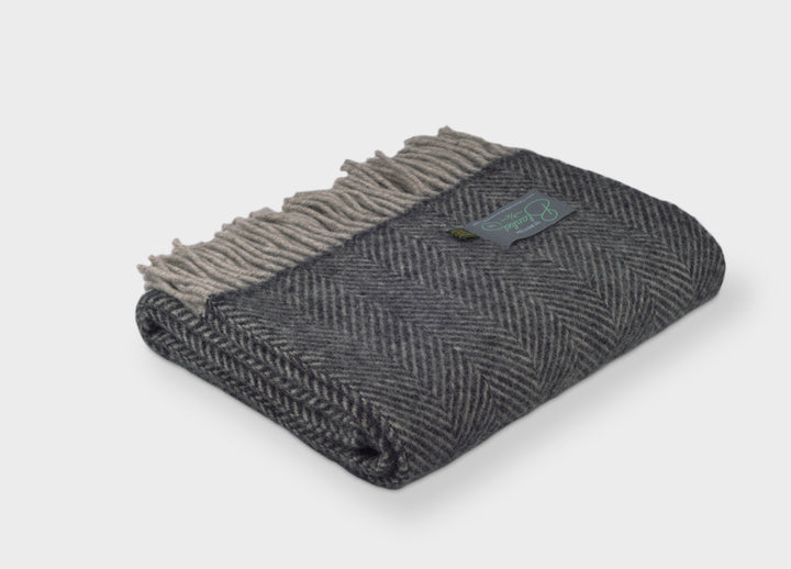 A grey herringbone wool throw by The British Blanket Company. 
