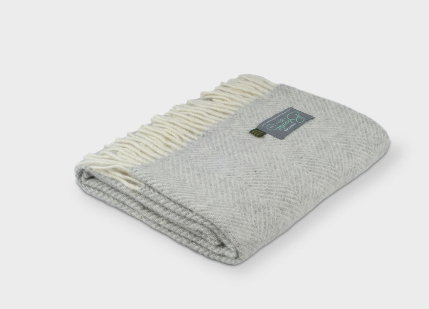 Folded grey herringbone wool throw by The British Blanket Company