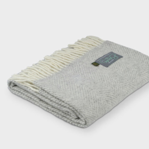 Folded grey herringbone wool throw by The British Blanket Company