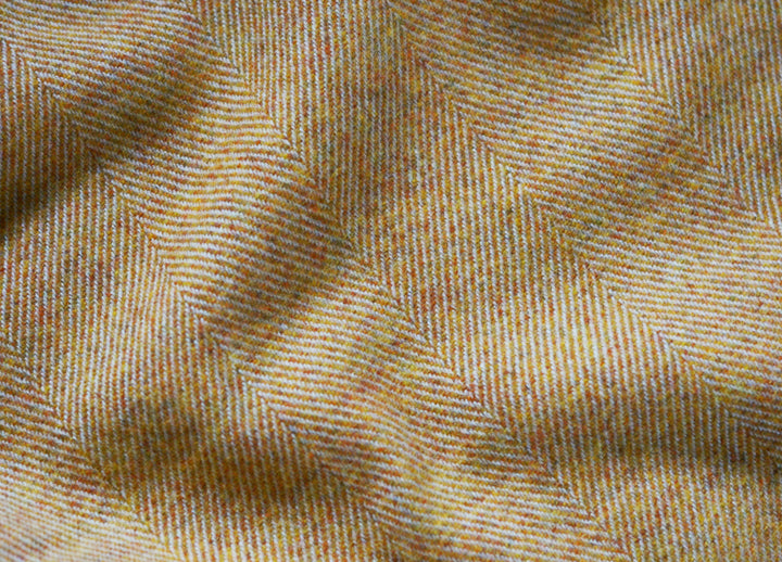 Closeup of large yellow merino herringbone wool blanket