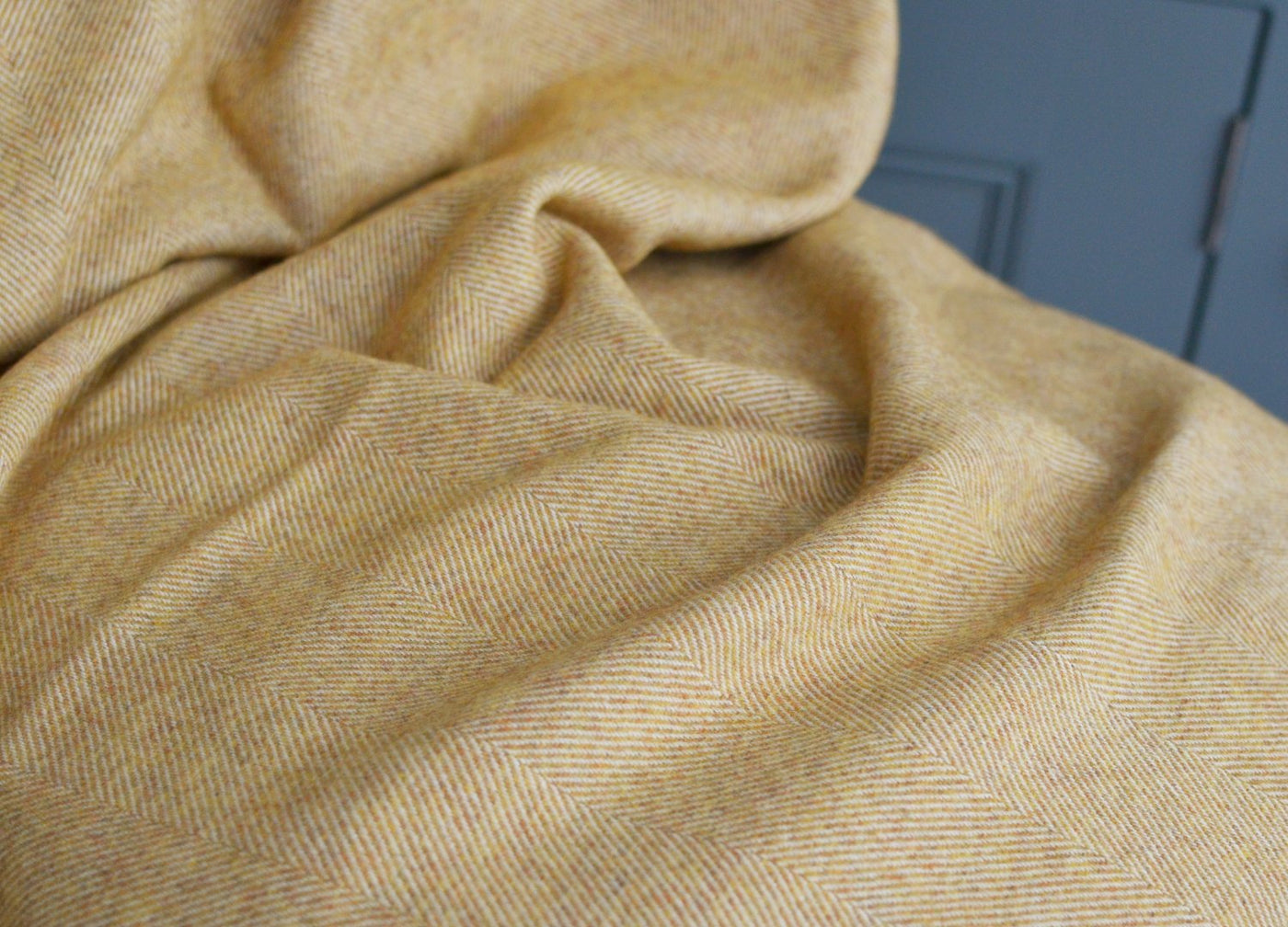 Closeup of an extra large yellow merino herringbone wool blanket