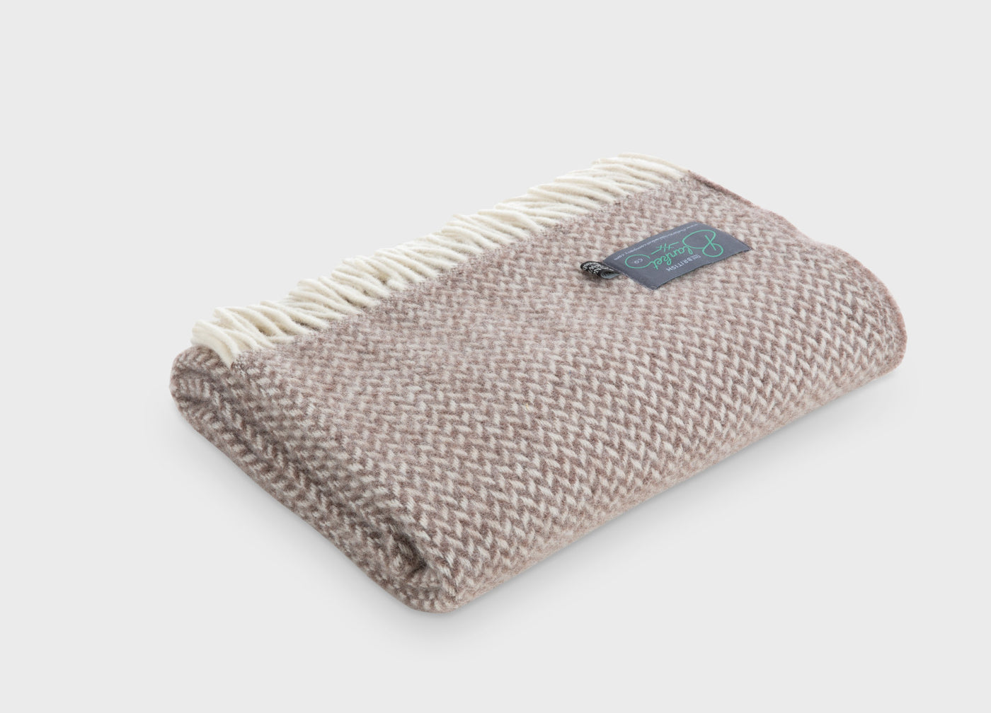 Folded brown herringbone wool throw by The British Blanket Company