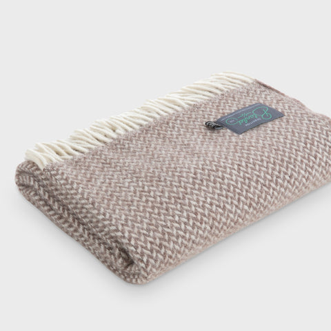 Folded brown herringbone wool throw by The British Blanket Company
