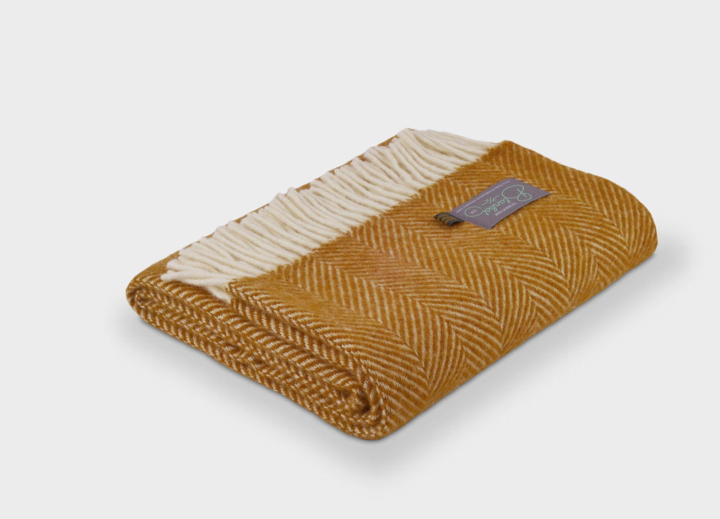 Folded yellow wool throw by The British Blanket Company