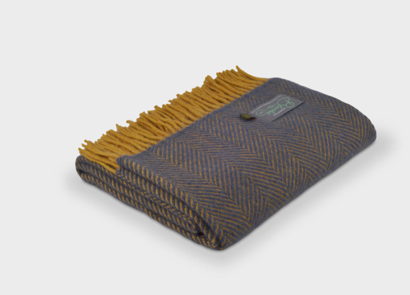 Folded blue and yellow herringbone wool throw by The British Blanket Company