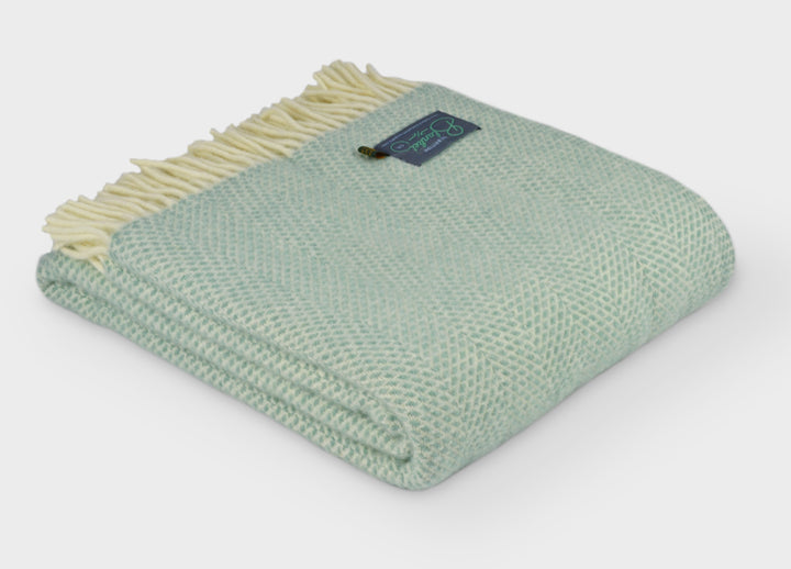 Folded large green beehive wool throw by The British Blanket Company