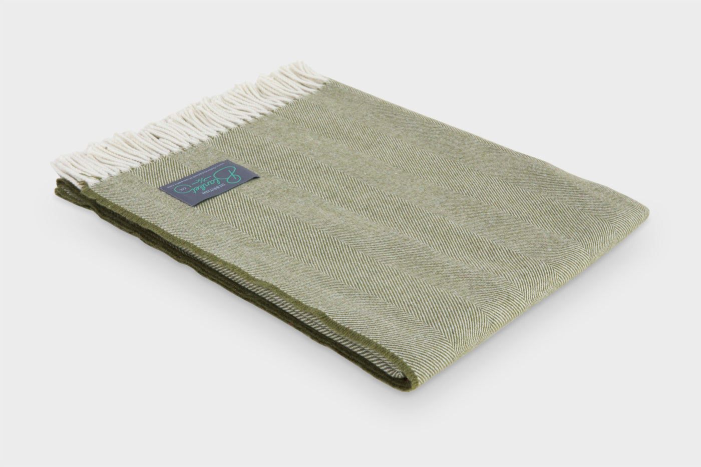 Folded green merino herringbone wool throw by The British Blanket Company