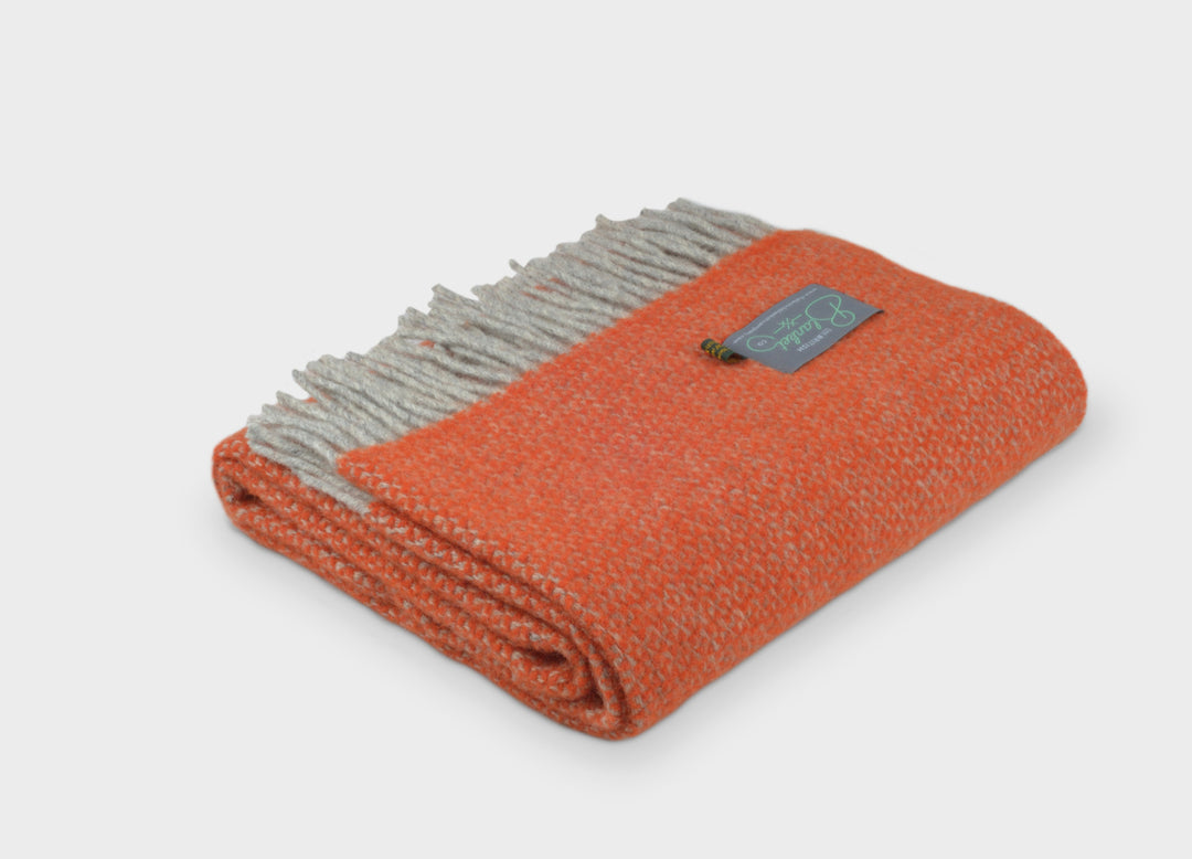 Folded orange and grey windmill wool throw by The British Blanket Company