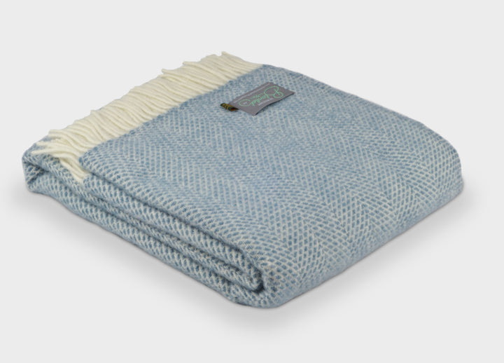 Folded large blue beehive wool throw by The British Blanket Company