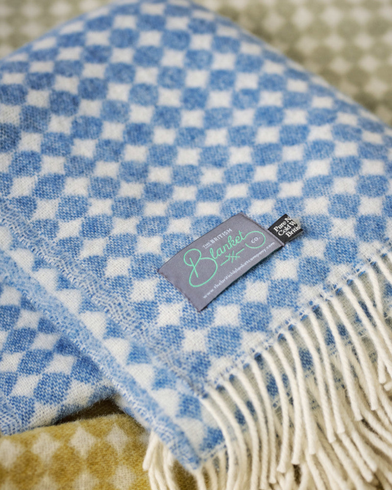 folded blue and cream spot pure wool throw blanket by The British Blanket Company online shop