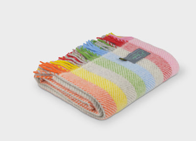 Folded rainbow stripe herringbone wool throw by The British Blanket Company