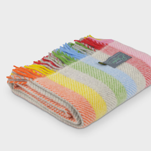 Folded rainbow stripe herringbone wool throw by The British Blanket Company