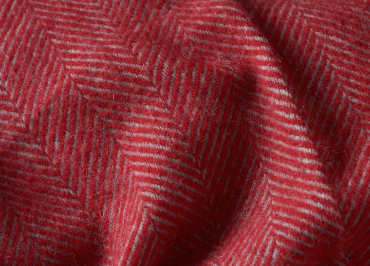 Closeup of a large red and grey herringbone wool blanket