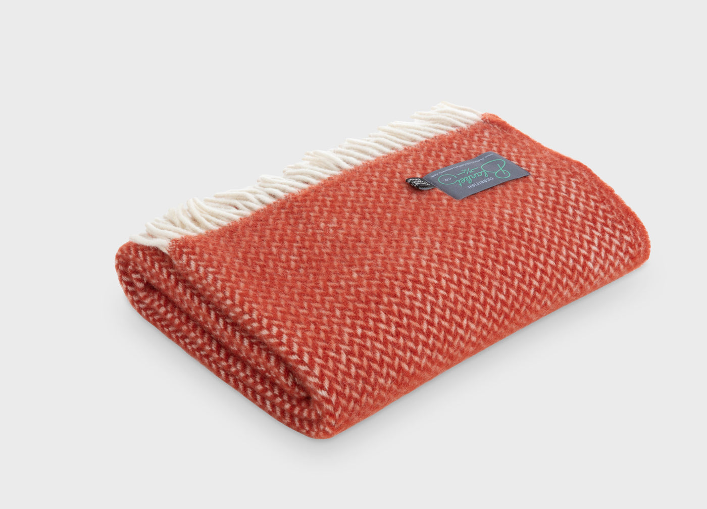 Folded red herringbone wool throw by The British Blanket Company