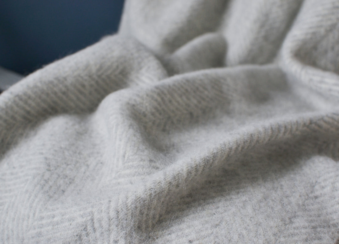 Closeup of silver grey herringbone wool blanket