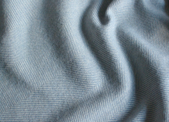 Closeup of a light blue merino herringbone wool blanket