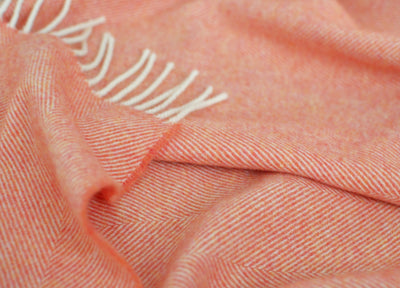 Closeup of orange merino herringbone wool blanket.